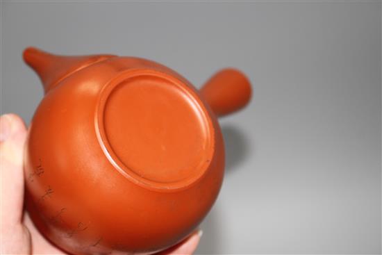 A Chinese Yixing teapot and cover, a redware teapot and cover and a cup